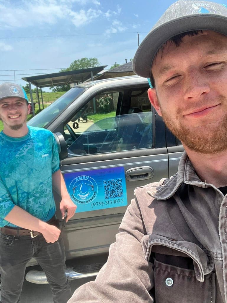 Kevin and Daniel of Sway Pressure Washing standing beside their branded work truck